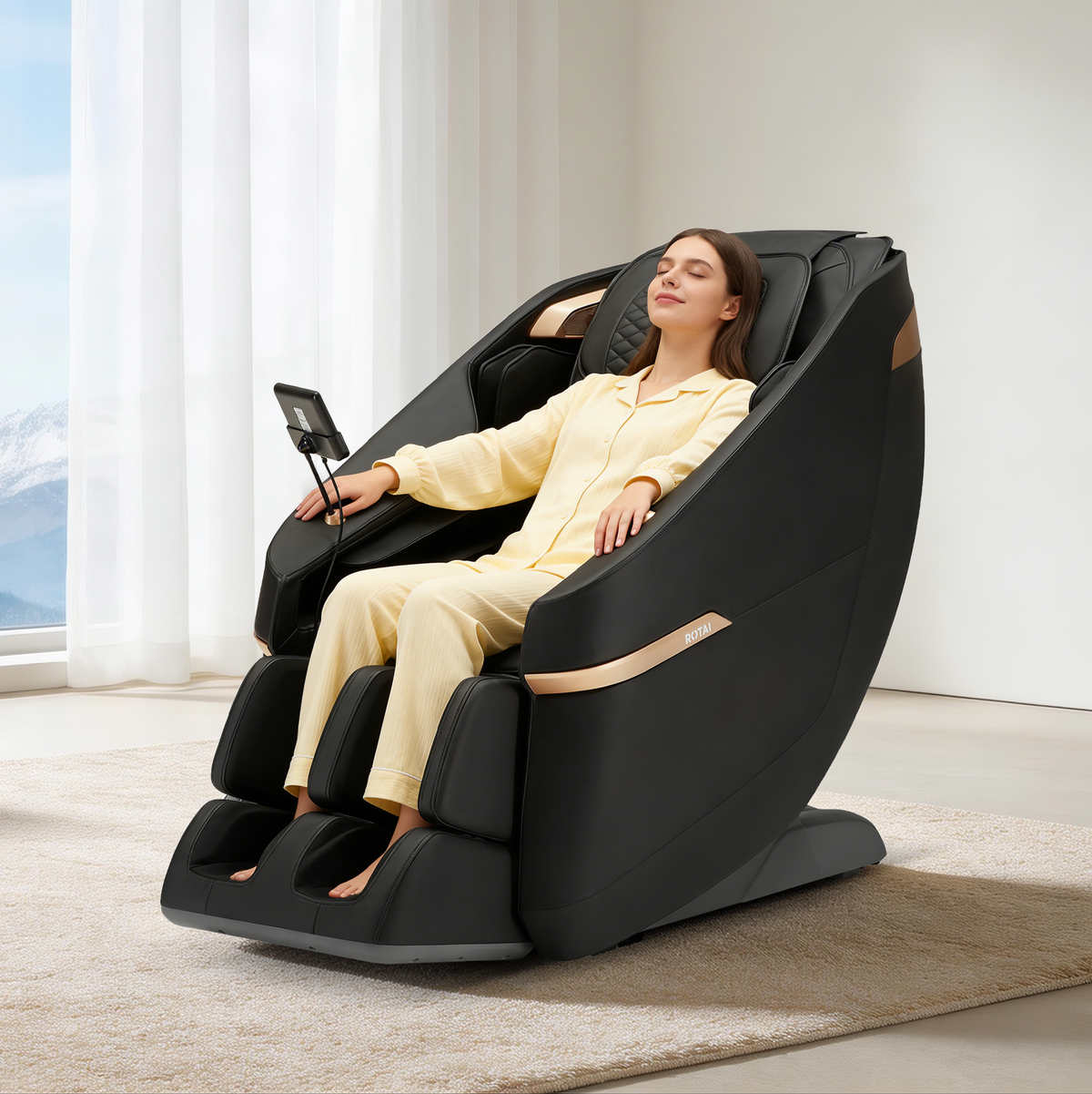 A woman in a pale yellow pajama set reclines in a black modern massage chair with gold trim, placed on a beige rug in a bright room with white curtains and a window.