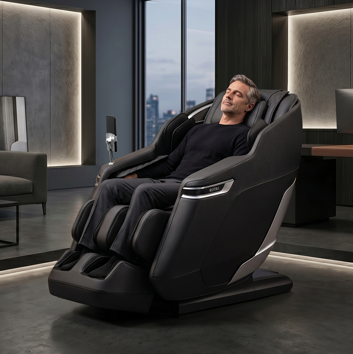A man reclines comfortably in a modern black and dark gray massage chair inside a stylish contemporary living room with city views.